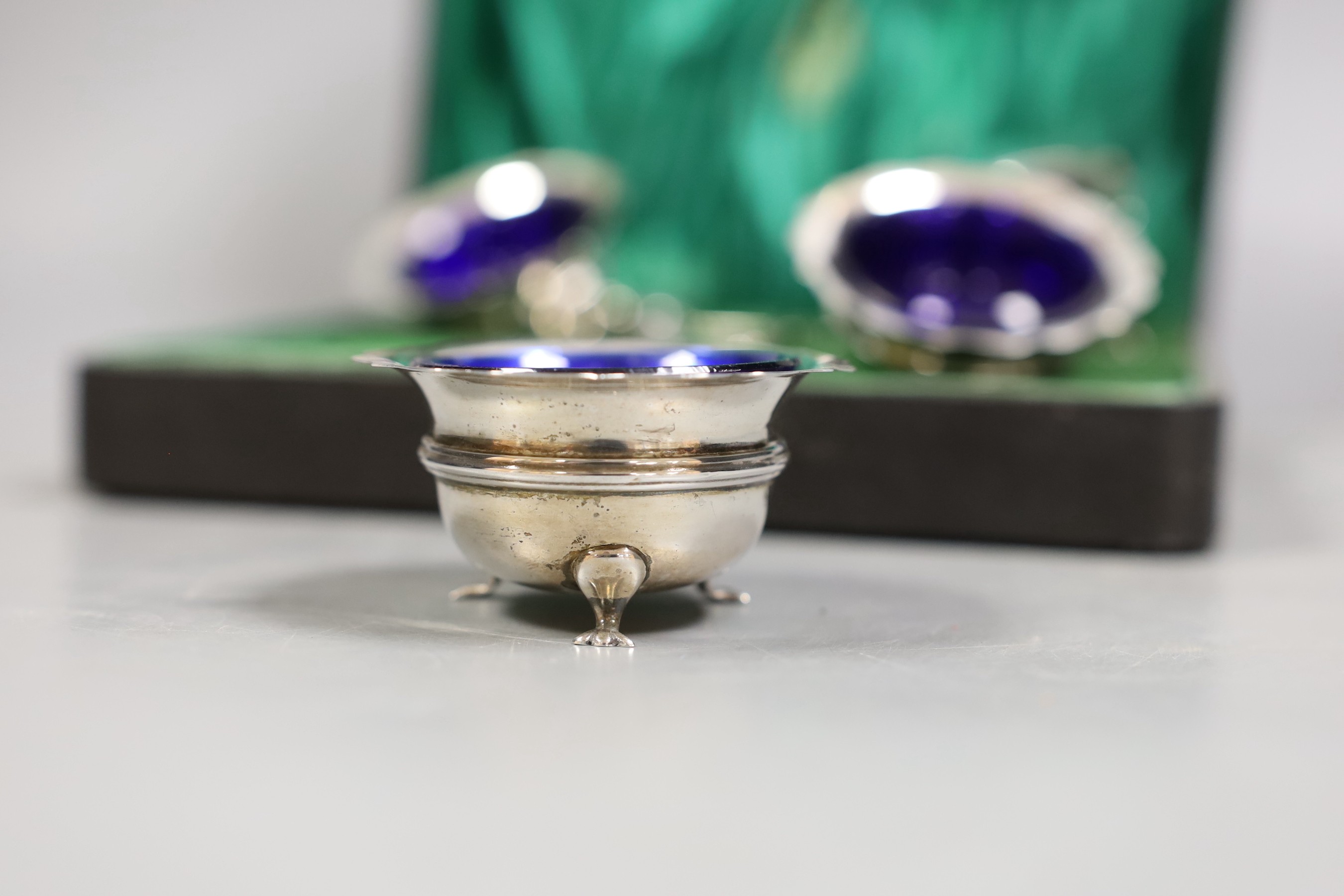 A cased set of four silver salts and four associated spoons, including plated.